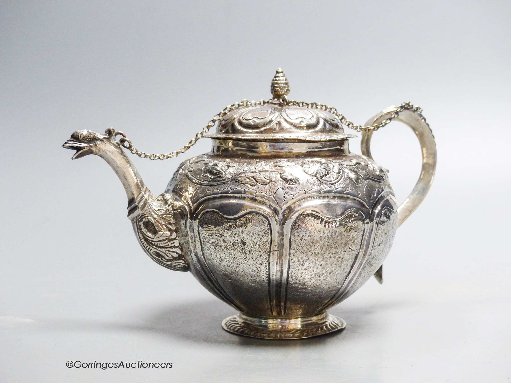 A late 18th/early 19th century Dutch? embossed white metal teapot, 13.5cm, gross 11.5oz
